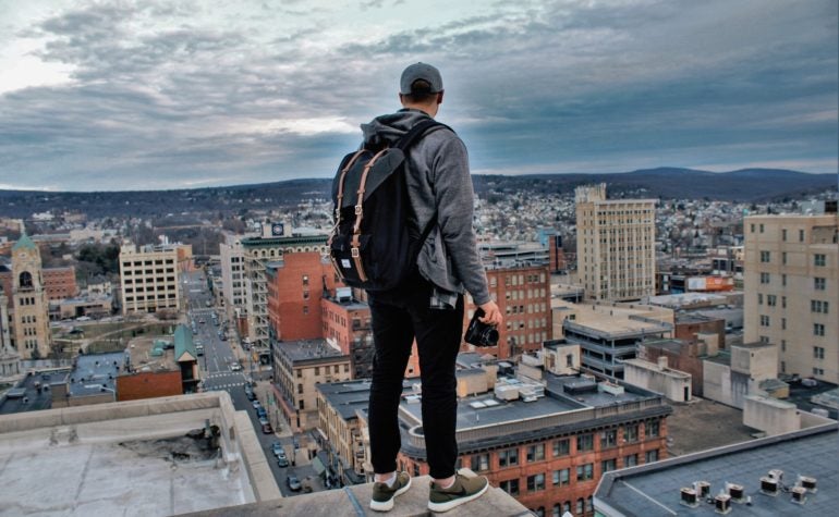 Man standing on building ledge